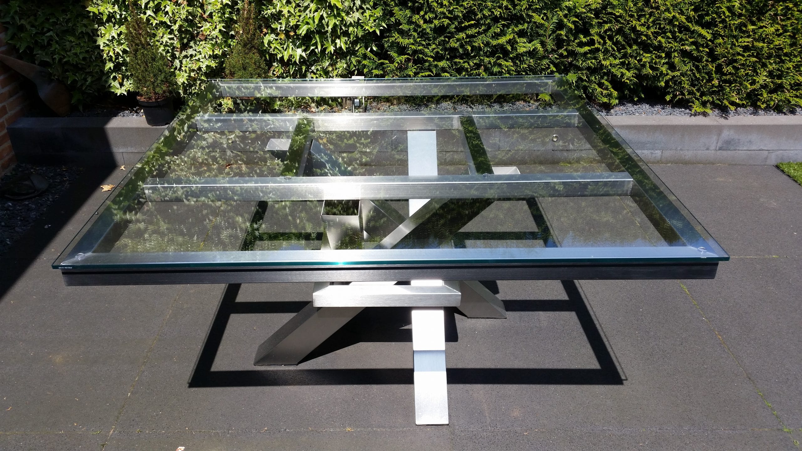 Glazen tafelblad op rvs design frame